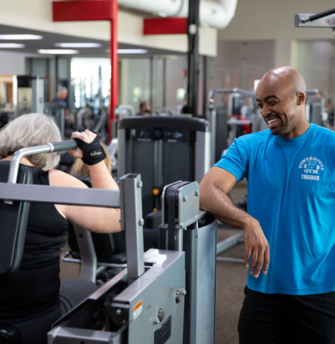 Man training woman in gym